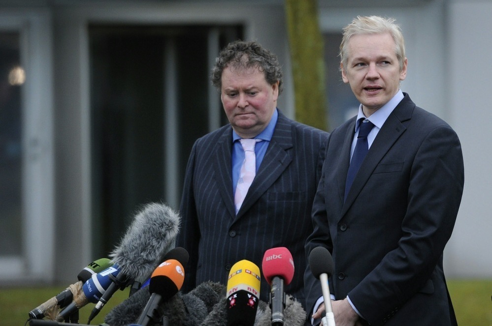 WikiLeaks founder Julian Assange addresses the media as his lawyer Mark Stephens looks on.