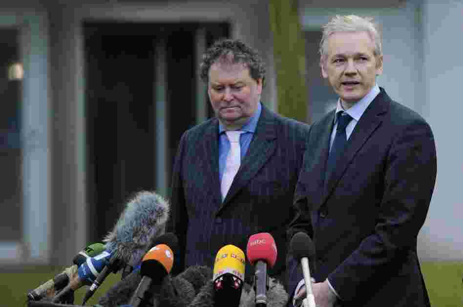 WikiLeaks founder Julian Assange addresses the media as his lawyer Mark Stephens looks on.