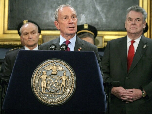 New York City Mayor Mayor Michael Bloomberg talks to the news media as Rep. Peter King (R-NY) stands to the mayor's left.