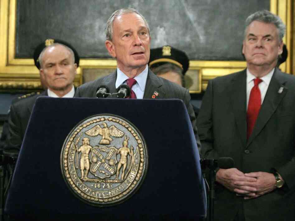 New York City Mayor Mayor Michael Bloomberg talks to the news media as Rep. Peter King (R-NY) stands to the mayor's left.