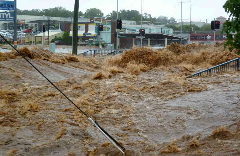 Water gushes into a shopping center in Toowoomba, Australia as the region braces for more deadly flooding.