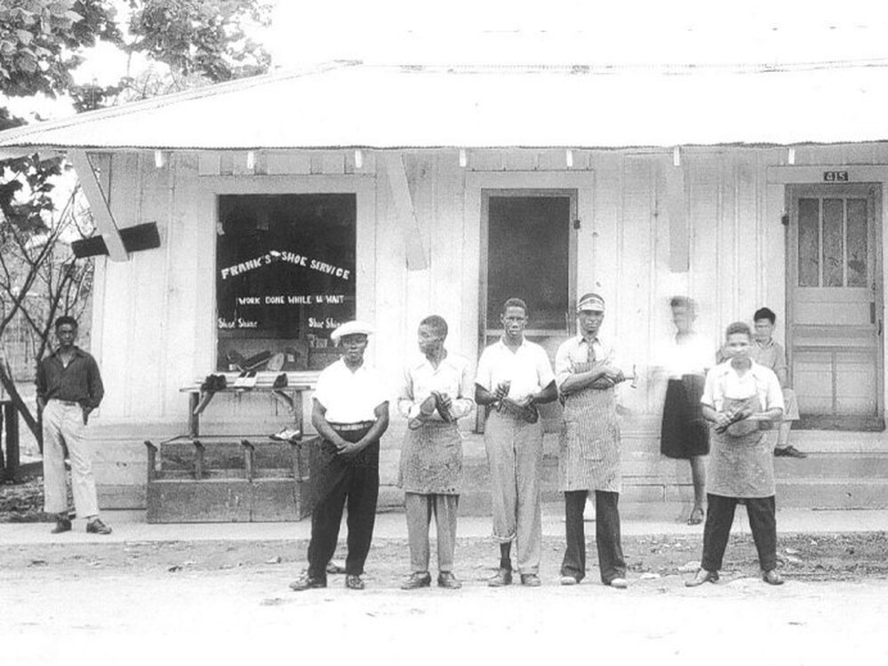 Frank Morris (in the apron and visor) is seen standing in front of his shoe shop in the 1950s. He was killed when his shoe shop burned down in Ferriday, La., in 1964.