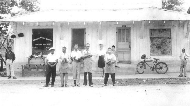 Frank Morris (in the apron and visor) is seen standing in front of his shoe shop in the 1950s. He was killed when his shoe shop burned down in Ferriday, La., in 1964.