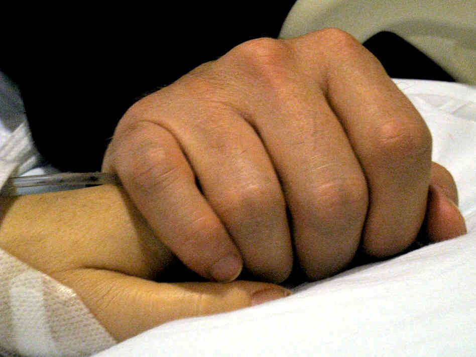 In a Tucson hospital room, Mark Kelly keeps vigil beside his wife, Rep. Gabrielle Giffords.