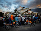Haitians watch the L.A. County Search and Rescue working at a collapsed building in downtown Port-au-Prince, Jan. 16, 2010. Haitians watch the L.A. County Search and Rescue working at a collapsed building in downtown Port-au-Prince, Jan. 16, 2010.