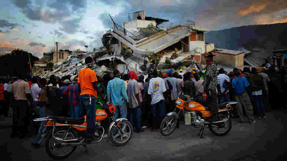 Haitians watch the L.A. County Search and Rescue working at a collapsed building in downtown Port-au-Prince, Jan. 16, 2010. Haitians watch the L.A. County Search and Rescue working at a collapsed building in downtown Port-au-Prince, Jan. 16, 2010.