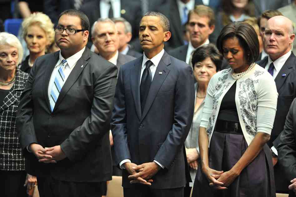 The Obamas stand next to Giffords' intern, Daniel Hernandez, who was honored as a hero at the event. Arizona Gov. Jan Brewer said Hernandez's quick actions probably saved Giffords' life. Hernandez rushed to help the congresswoman after she was shot. 