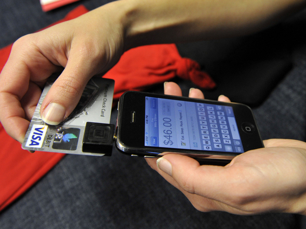 In this Dec. 18, 2009, photo, Willo O'Brien demonstrates Square on her iPhone in San Francisco. O'Brien, a designer and illustrator, uses Square for credit card transactions with her customers. Users can sign for purchases by writing with a finger on the iPhone's touch screen.