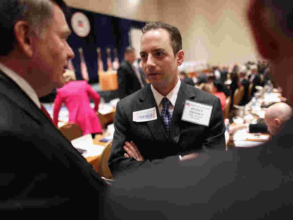 Reince Priebus talks with members during the Republican National Committee meeting on Friday in Oxon Hill, Md. Priebus was selected as RNC chairman after seven rounds of voting.