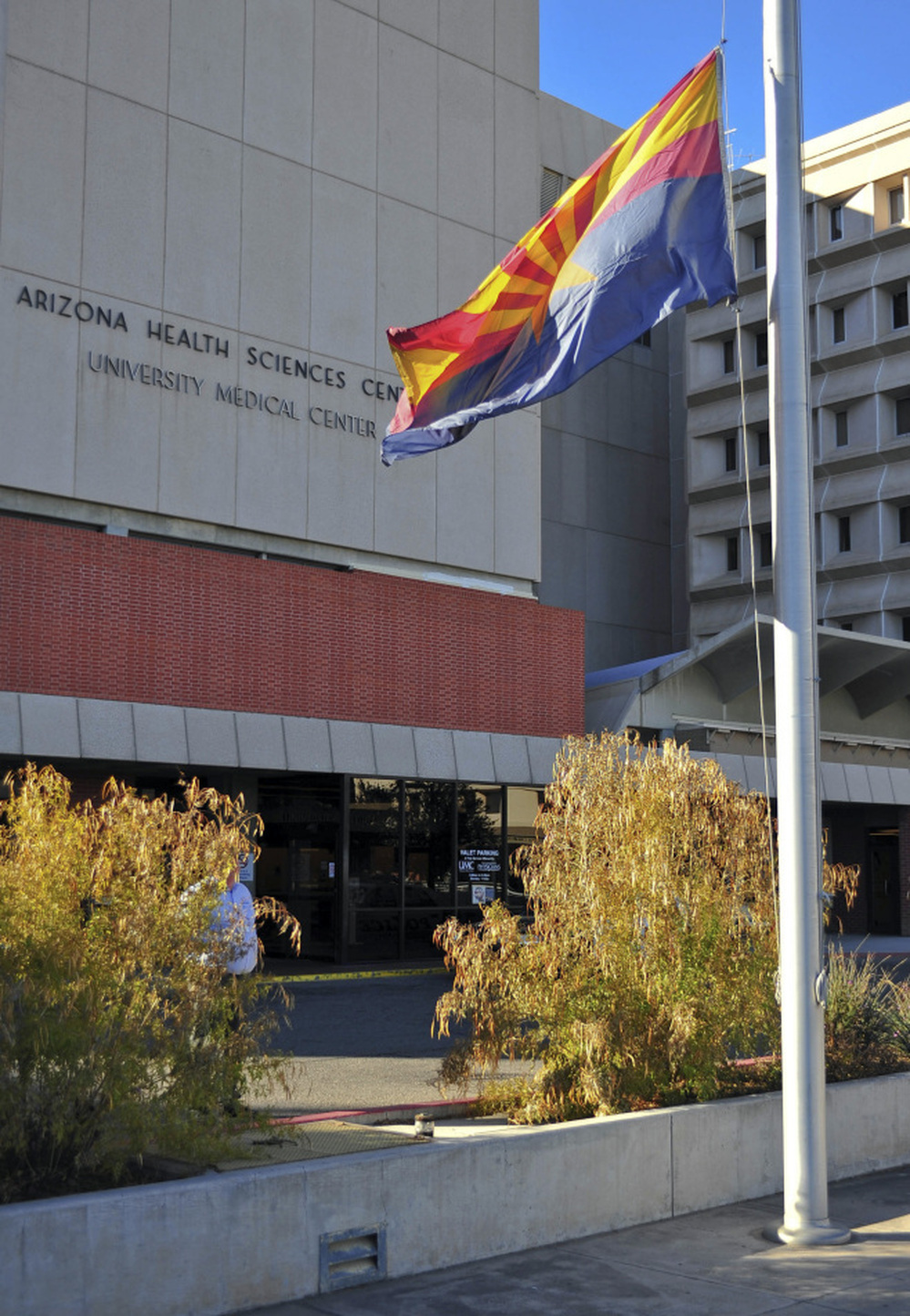The flag of the state of Arizona flies at half-staff outside University Medical Center in Tucson, Ariz., on Jan. 8.