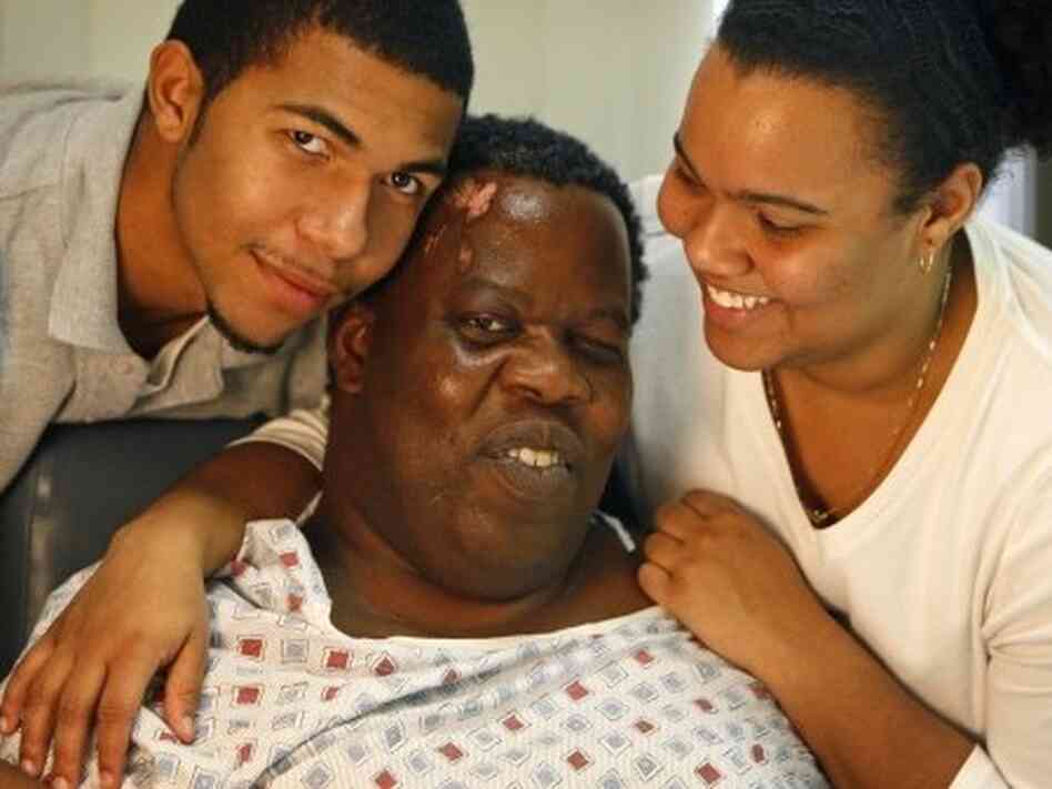 Romel Joseph (center), his son Bradley, and his daughter Victoria at the hospital where Romel was treated for his injuries in January of last year. Romel Joseph (center), his son Bradley, and his daughter Victoria at the hospital where Romel was treated for his injuries in January of last year.