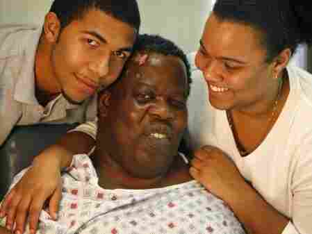 Romel Joseph (center), his son Bradley, and his daughter Victoria at the hospital where Romel was treated for his injuries in January of last year. Romel Joseph (center), his son Bradley, and his daughter Victoria at the hospital where Romel was treated for his injuries in January of last year.