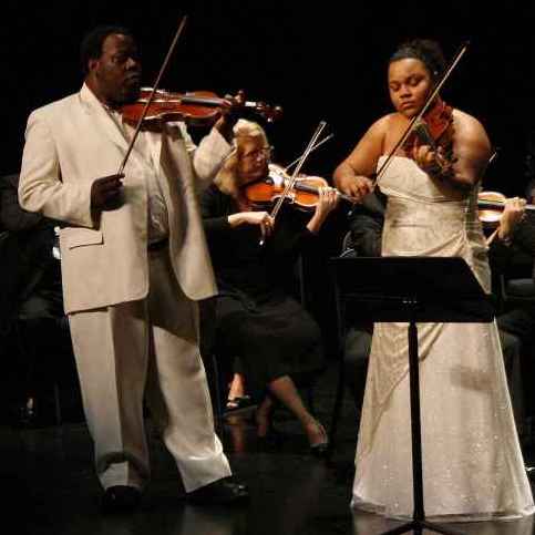 Romel Joseph, founder of The New Victorian School in Haiti, and his daughter Victoria perform at the Aventura Cultural Center in Miami on Jan. 8. It was Joseph's first performance since last year's earthquake.