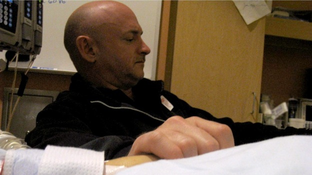 Mark Kelly, husband of U.S. Rep. Gabrielle Giffords (D-AZ), holds his wife's hand.