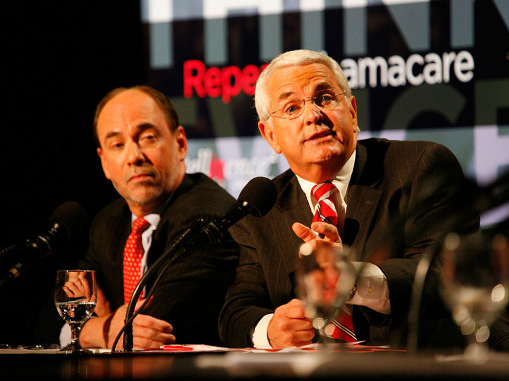 Douglas Holtz-Eakin (left) and John Shadegg debated in favor of repealing the new health care law.