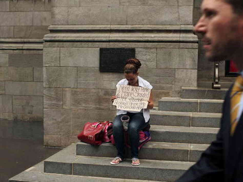 A business man walks by a homeless woman holding a card requesting money in New York City. A new report released by the U.S. Census Data shows that the income gap between Americans is greater than at any other time on record. A business man walks by a homeless woman holding a card requesting money in New York City. A new report released by the U.S. Census Data shows that the income gap between Americans is greater than at any other time on record.