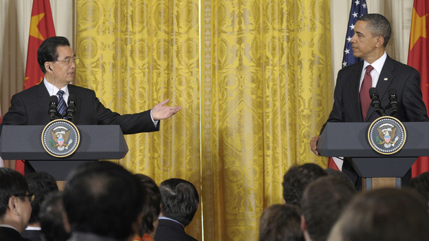 China's President Hu Jintao gestures toward President Obama during their joint news conference, Wednesday in the East Room of the White House.