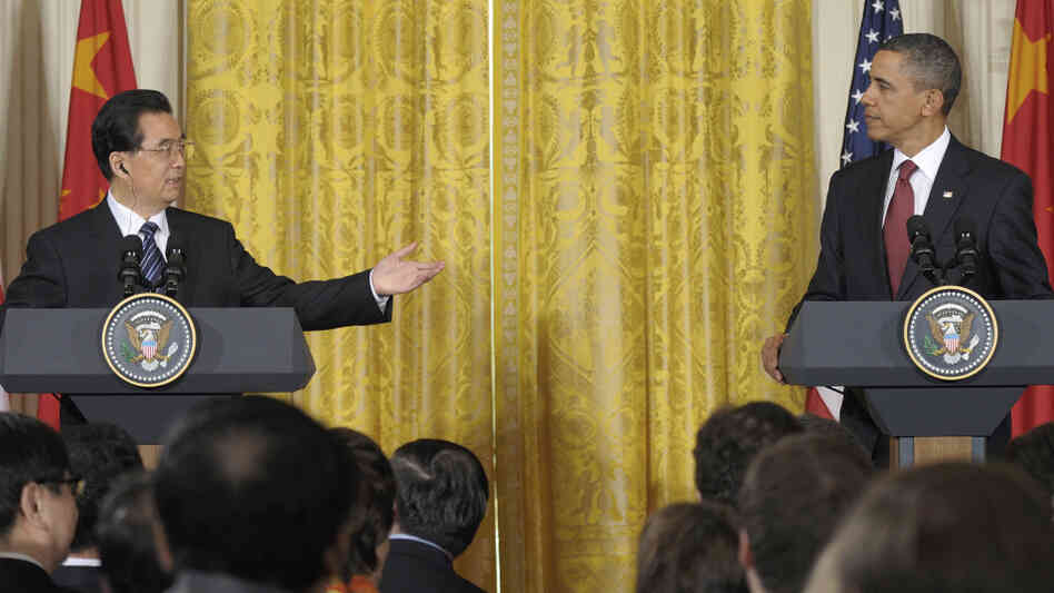 China's President Hu Jintao gestures toward President Obama during their joint news conference, Wednesday in the East Room of the White House.