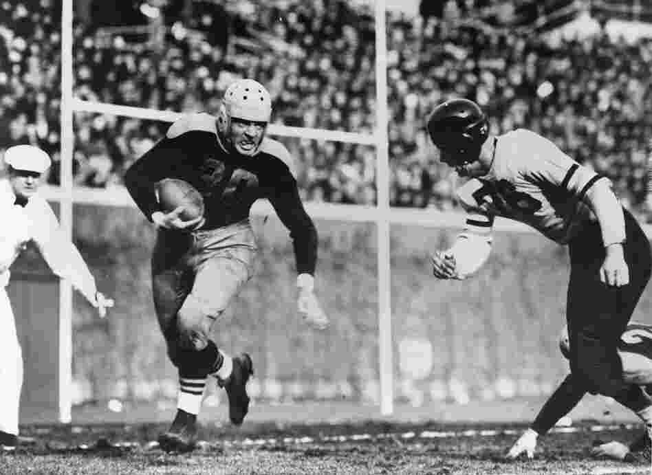 In the 1941 game, Green Bay Packers Hall of Fame running back Clarke Hinkle (left) tries to get past Chicago Bears defender Hampton Pool.