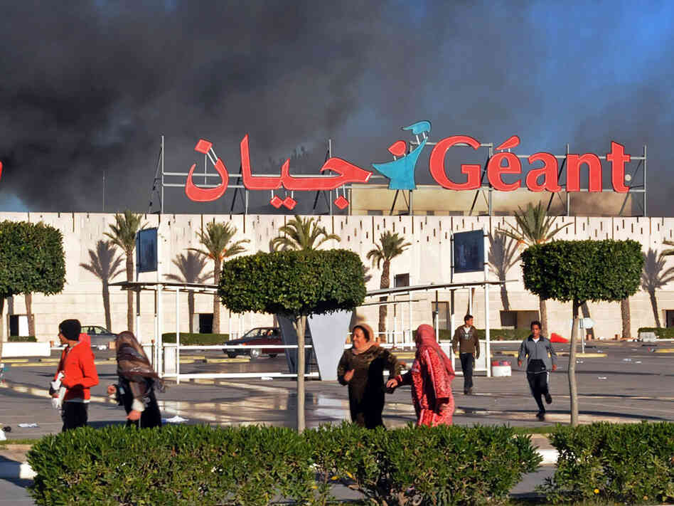 A supermarket smolders after it was sacked and looted in Bizerte, Tunisia, on Jan. 15. Despite the continuation of random attacks by forces loyal to the country's former president, residents of the northern port city say they are striving to get on with their lives. A supermarket smolders after it was sacked and looted in Bizerte, Tunisia, on Jan. 15. Despite the continuation of random attacks by forces loyal to the country's former president, residents of the northern port city say they are striving to get on with their lives.