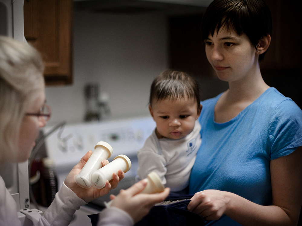 Ward picks up her donated breast milk  from fellow mother Natalie Erdossy in Reston, Va., on Jan. 12. Erdossy is one of more than eight nursing mothers who have donated milk to  Ward.