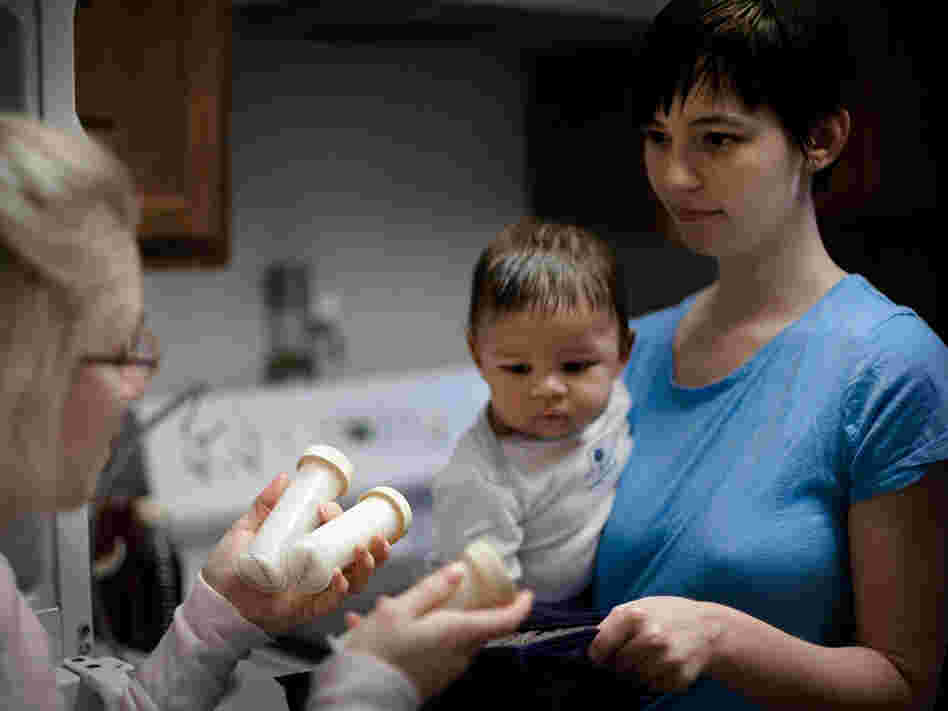 Ward picks up her donated breast milk  from fellow mother Natalie Erdossy in Reston, Va., on Jan. 12. Erdossy is one of more than eight nursing mothers who have donated milk to  Ward.