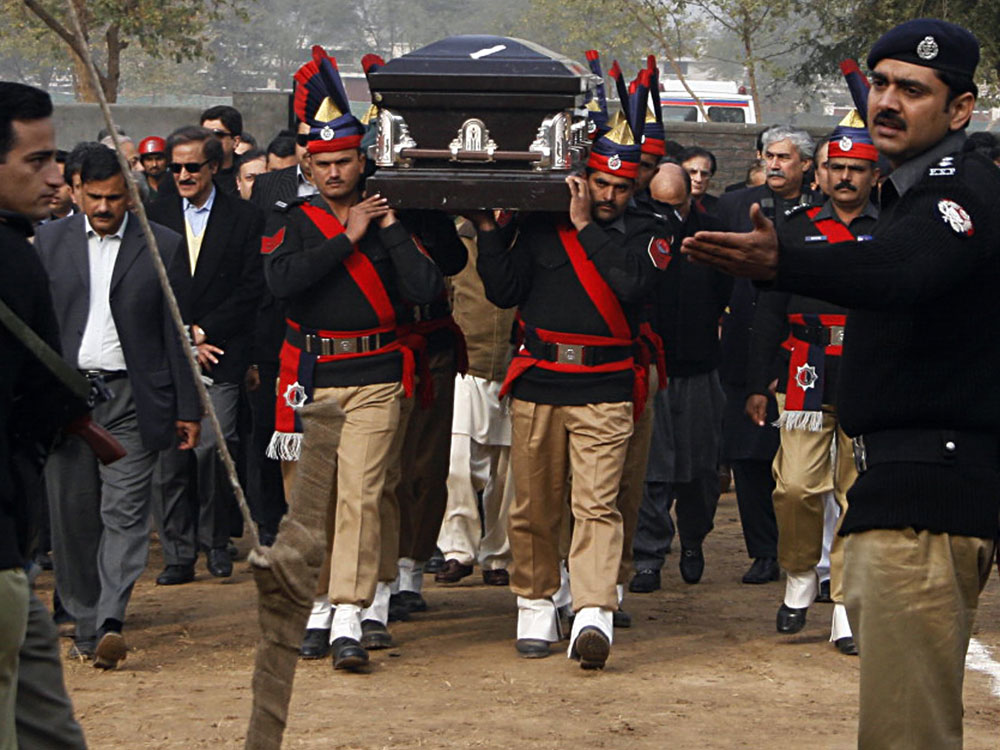 Pakistani police guards carry the coffin of the assassinated governor of Punjab, Salman Taseer, during the funeral procession in Lahore on Jan. 5.