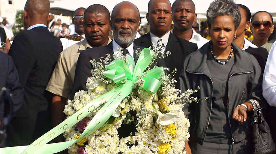 Haitian President Rene Preval (center) prepares to lay a wreath on Jan. 11 at St. Christophe in Port-au-Prince, where thousands of victims of the Jan. 12, 2010, earthquake are buried. Haitian President Rene Preval (center) prepares to lay a wreath on Jan. 11 at St. Christophe in Port-au-Prince, where thousands of victims of the Jan. 12, 2010, earthquake are buried.