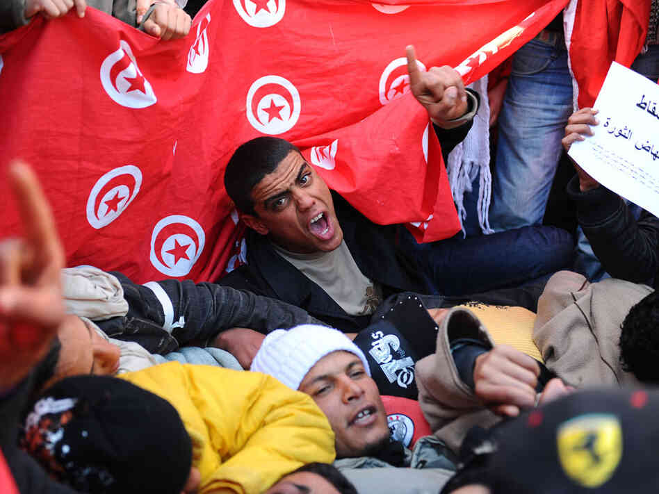 Inhabitants of the poverty-stricken central Tunisia region of Sidi Bouzid, chant slogans during a demonstration Sunday outside the government palace in Tunis. Inhabitants of the poverty-stricken central Tunisia region of Sidi Bouzid, chant slogans during a demonstration Sunday outside the government palace in Tunis.