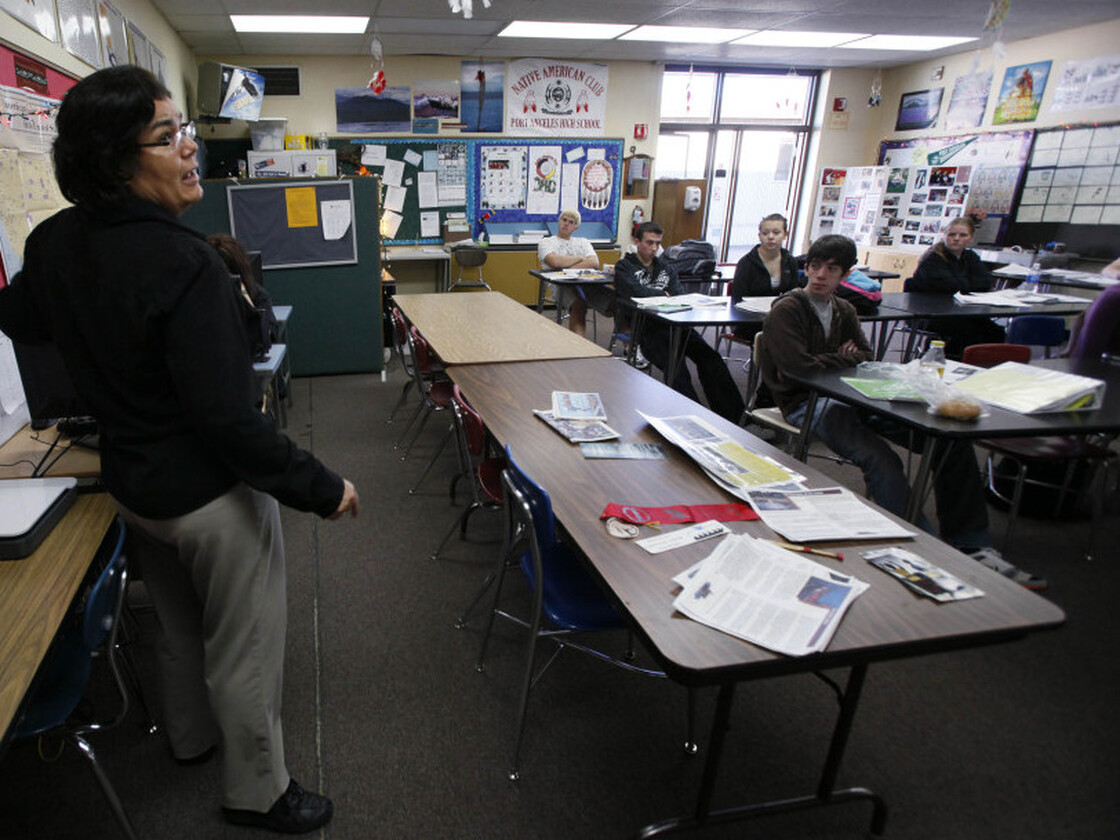 A teacher talks to her students.