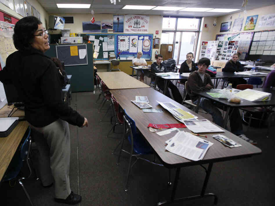 A teacher talks to her students.