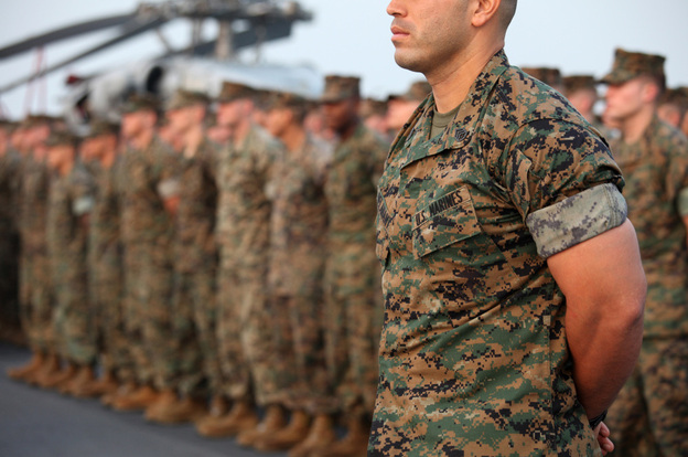 U.S. Marines attend a role call on the flight deck of the USS Essex, a  multipurpose amphibious assault ship, in November. Defense Secretary Robert Gates says he wants reduce the Marine Corps by some 15,000 to 20,000 in the coming years.