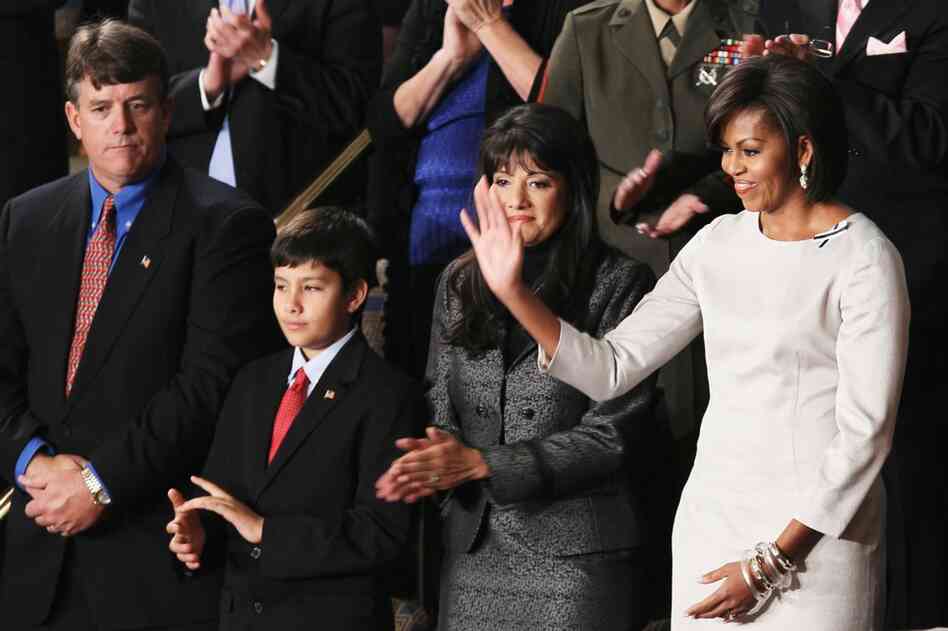 First lady Michelle Obama stands with John (from left), Dallas and Roxanna Green, the family of Arizona shooting victim Christina Green. 