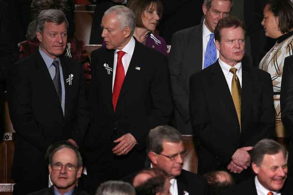 Montana Democratic Sen. Max Baucus (from left) talks with Sen. Orrin Hatch (R-UT) as Sen. Jim Webb (D-VA) looks on before the speech. 