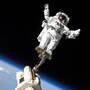 Mission Specialist Stephen K. Robinson works from a boom arm connected to the International Space Station. Mission Specialist Stephen K. Robinson works from a boom arm connected to the International Space Station.