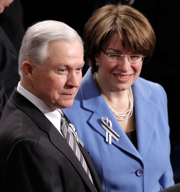 Sen. Jeff Sessions (R-AL) and Sen. Amy Klobuchar, (D-MN) prepare to sit together. 