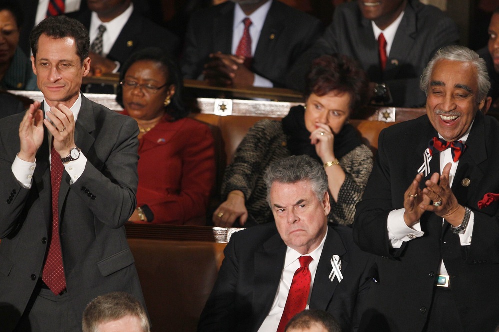 Rep. Peter King (R-NY), center, finds little to enjoy as Rep. Anthony Weiner (D-NY), left, and Rep. Charles Rangel, (D-NY), right, applaud during President Barack Obama's State of the Union address. King and Anthony Weiner screamed at each other on Fox New last summer. 