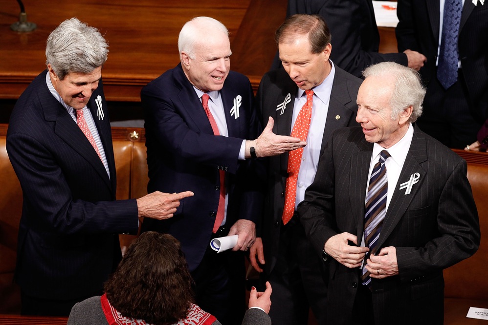 Former presidential contenders Sen. John Kerry (D-MA), Sen. John McCain (R-AZ) and Sen. Joe Lieberman (I-CT), far right, talk with Sen. Mark Udall (D-CO), center right. 