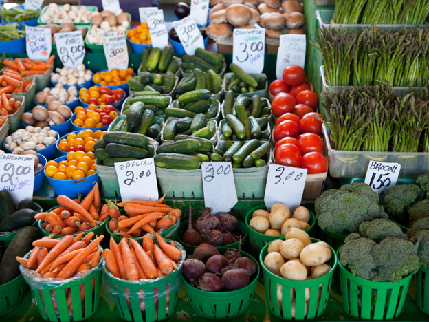 Fresh produce piled high at a farmers' market.