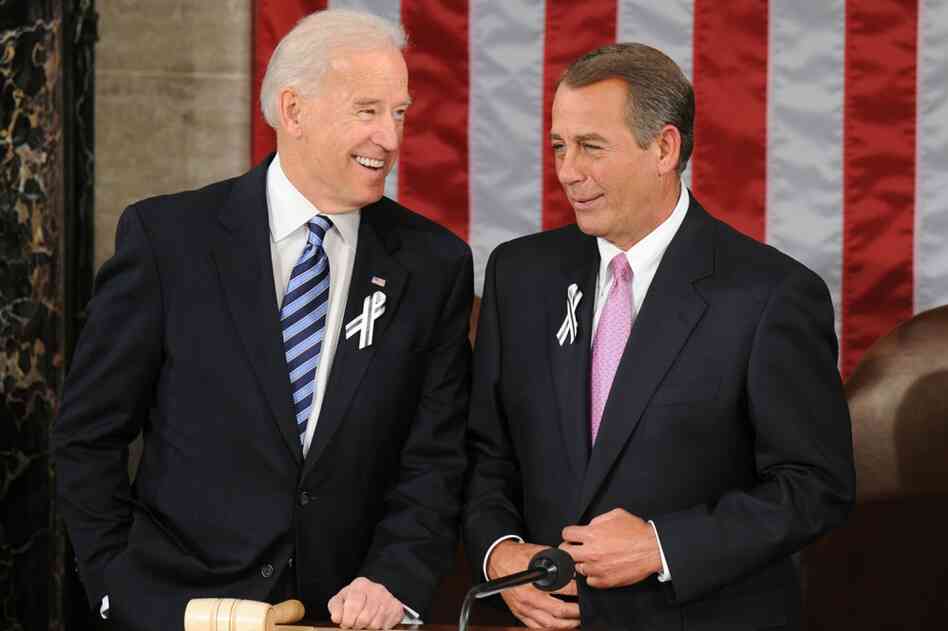 Biden and Boehner wear black-and-white ribbons in honor of the Arizona shooting victims. 