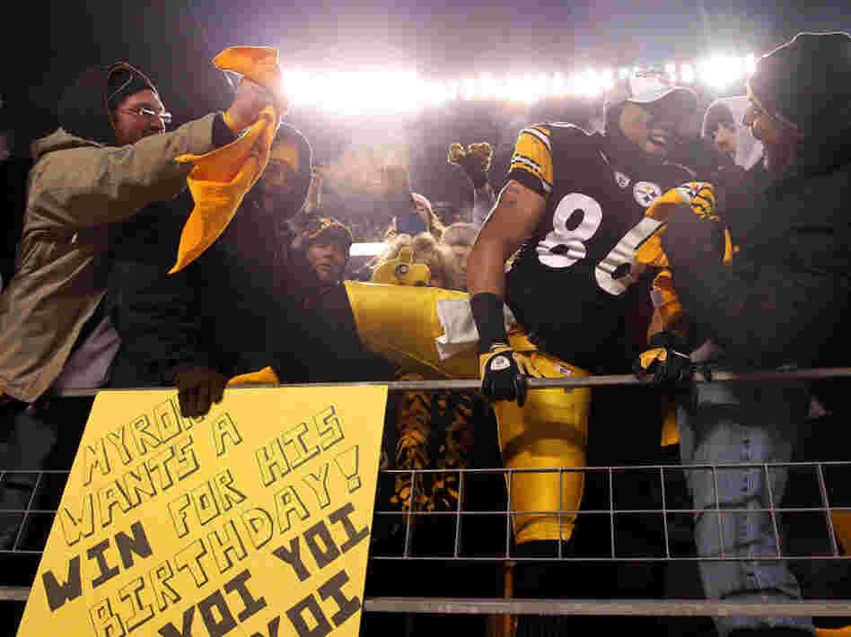 Hines Ward of the Pittsburgh Steelers climbs into the stands to celebrate with fans after their win over the New York Jets in the AFC Championship game.