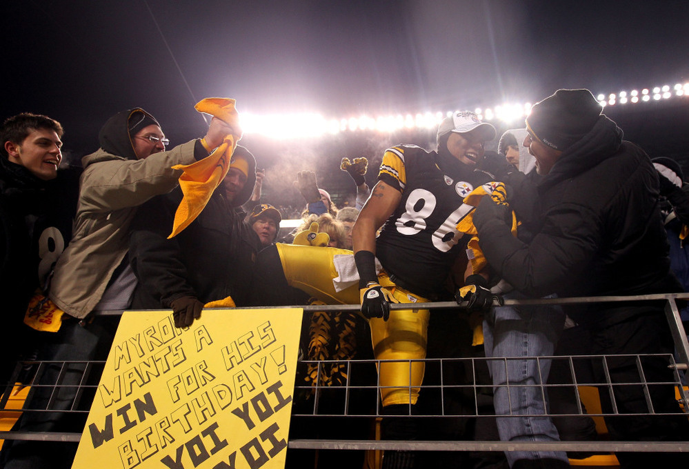 Hines Ward of the Pittsburgh Steelers climbs into the stands to celebrate with fans after their win over the New York Jets in the AFC Championship game.