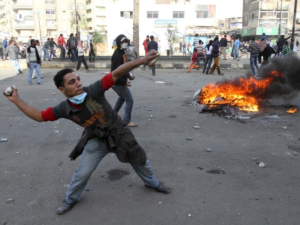 Egyptian demonstrators throw stones at Egyptian police during demonstration in Suez demanding the ouster of President Hosni Mubarak. Mubarak has been ruling the country for nearly three decades, and is expected to pass the presidency to his son, Gamal.