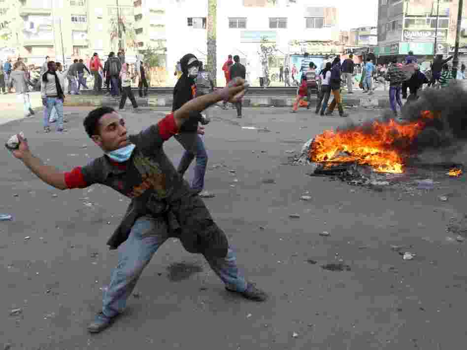 Egyptian demonstrators throw stones at Egyptian police during demonstration in Suez demanding the ouster of President Hosni Mubarak. Mubarak has been ruling the country for nearly three decades, and is expected to pass the presidency to his son, Gamal.
