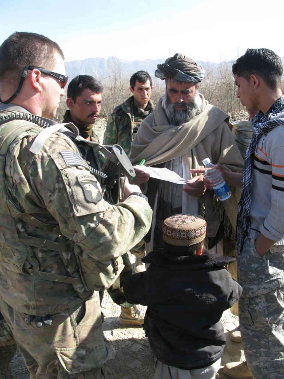 U.S. Army Capt. Pat McGuigan stands with a land-owner from Tarook Kalacha who has a hand-drawn plan of his house the Americans have promised to rebuild. U.S. Army Capt. Pat McGuigan stands with a land-owner from Tarook Kalacha who has a hand-drawn plan of his house the Americans have promised to rebuild.