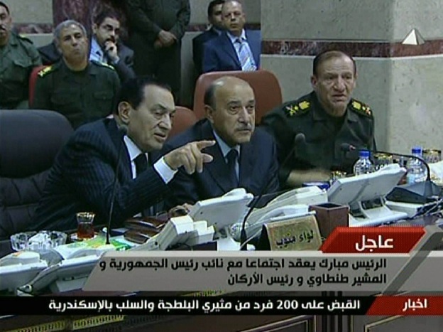 An image grab taken from Egyptian state television shows Egyptian President Hosni Mubarak (left) speaking with his new Vice President Omar Suleiman (center) and Chief of Staff Sami Anan during a visit to the military operations center in Cairo on Sunday.