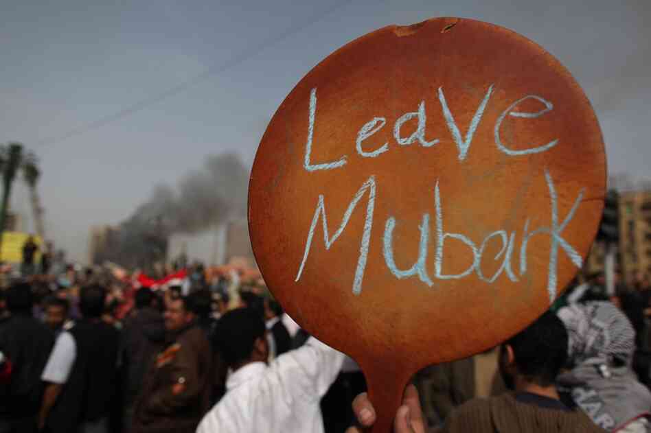 A protestor in Tahrir Square holds up a sign calling on President Mubarak to leave. Riot police and the army have been sent to quell the protests, which so far have claimed nearly 100 lives.  