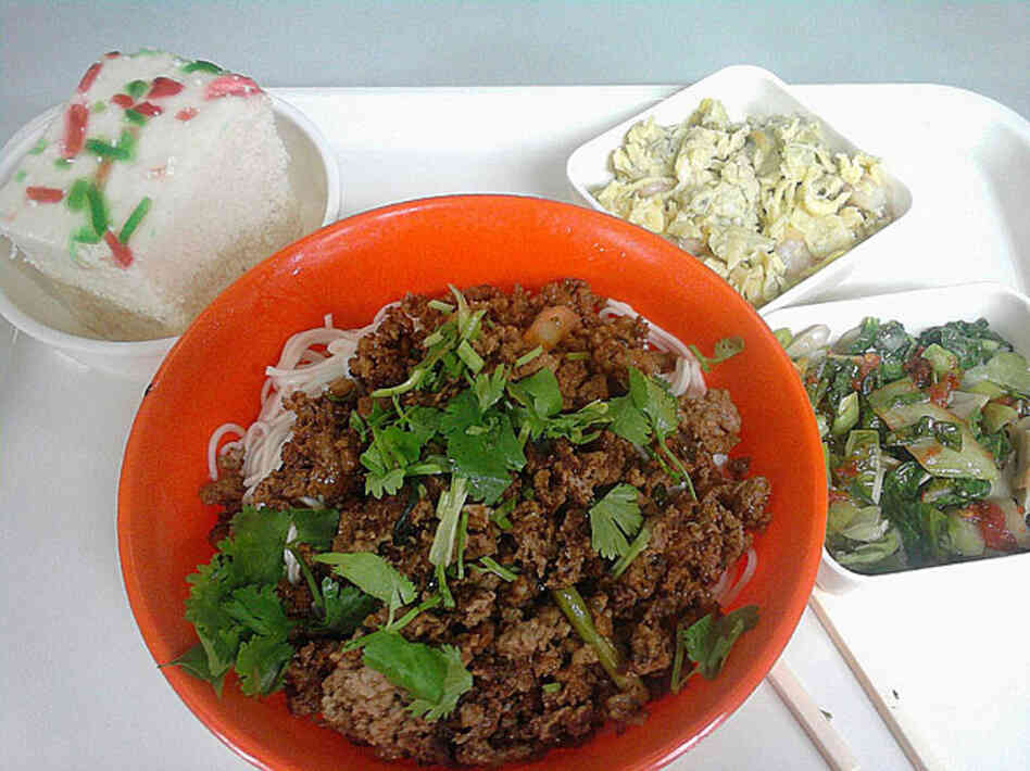 Shanghai, China, 2006. Rice-flour bread, egg and cauliflower, cabbage, and wheat noodles with pork. 