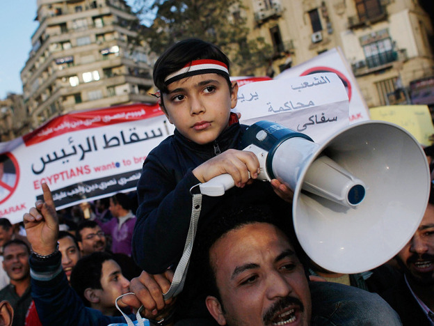 An Egyptian boy holds a megaphone while protesting in Tahrir Square in central Cairo, Egypt.  Protests continued unabated as thousands march to demand the resignation of Egyptian President Hosni Mubarek.