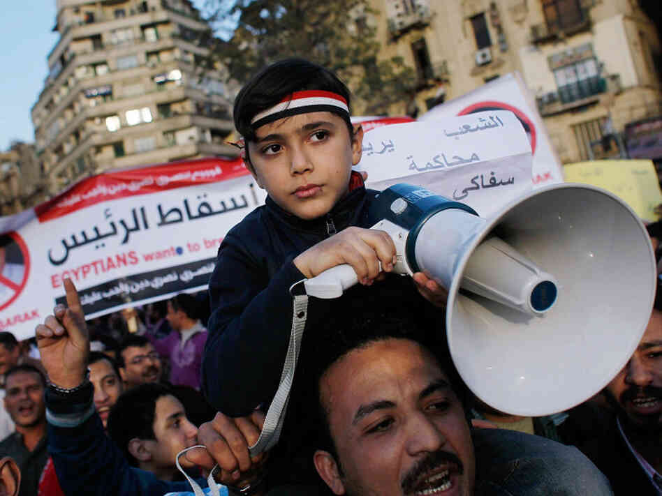 An Egyptian boy holds a megaphone while protesting in Tahrir Square in central Cairo, Egypt.  Protests continued unabated as thousands march to demand the resignation of Egyptian President Hosni Mubarek.